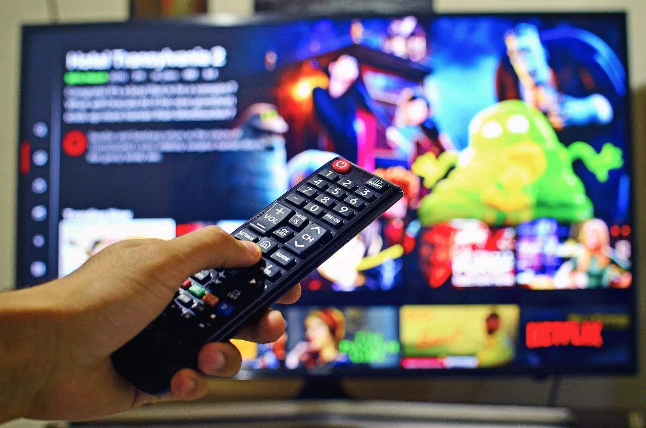 A remote control pointed at a television streaming menu